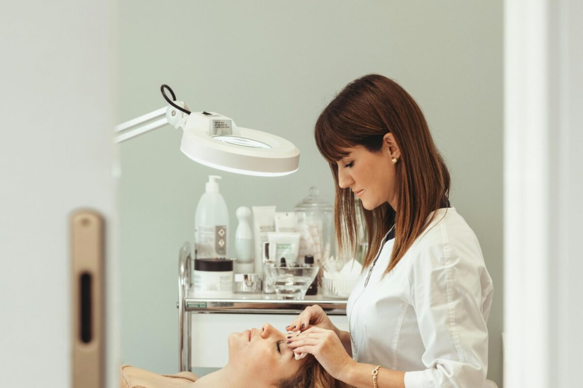 Beautician performs facial treatment in salon, enhancing skincare and relaxation.